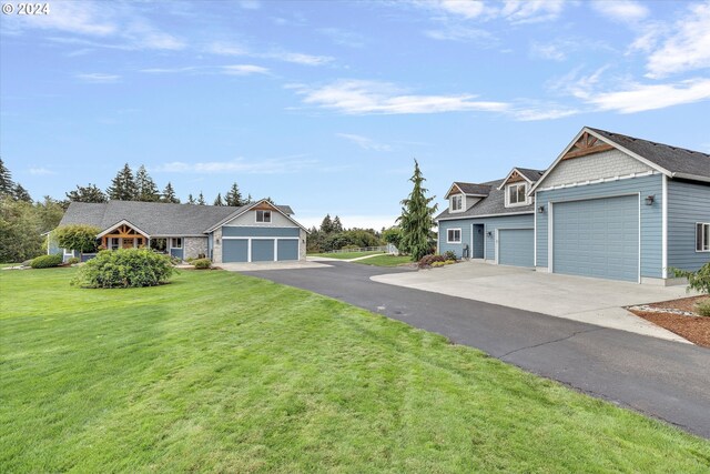 view of front of house with a garage and a front lawn