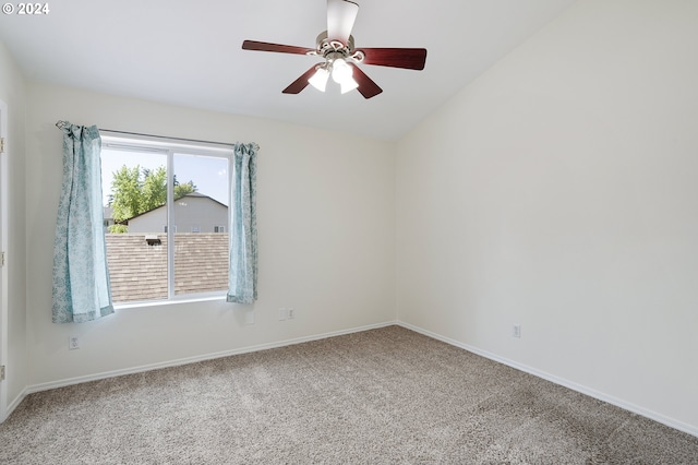 empty room featuring carpet, ceiling fan, and vaulted ceiling