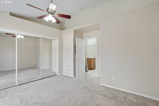 unfurnished bedroom with a closet, light carpet, and ceiling fan