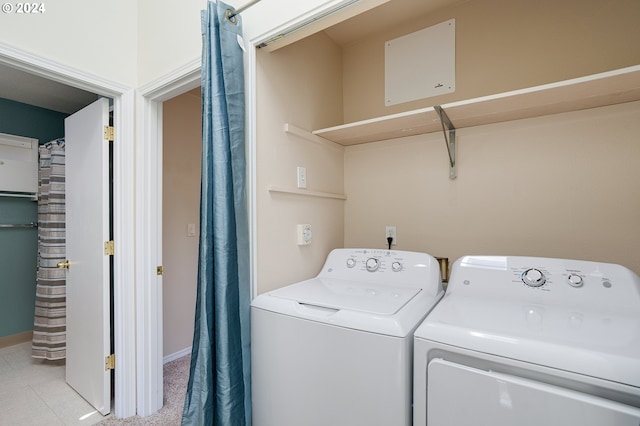 clothes washing area with washing machine and dryer