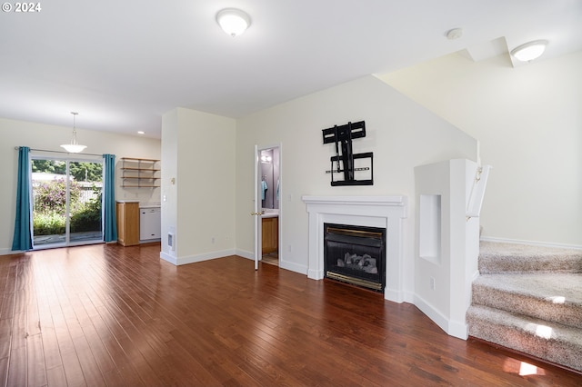 unfurnished living room featuring dark hardwood / wood-style flooring