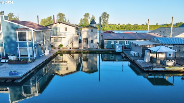 view of swimming pool with a water view and area for grilling