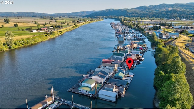 aerial view featuring a water and mountain view