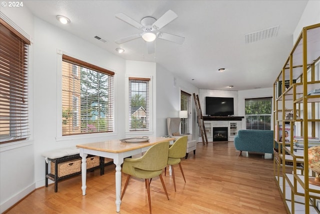 dining space featuring ceiling fan and light wood-type flooring