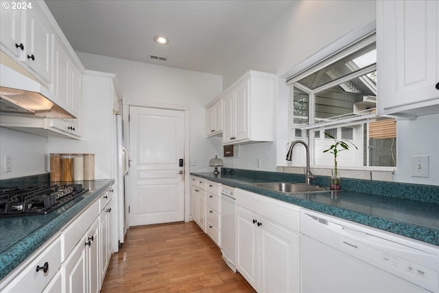 kitchen with white cabinets, white dishwasher, light hardwood / wood-style floors, and sink