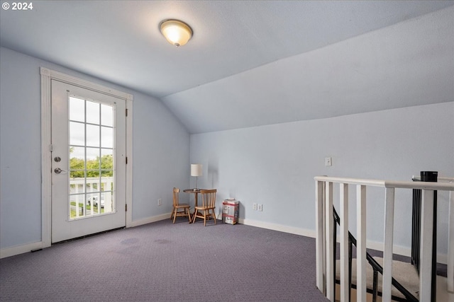 additional living space featuring carpet flooring and vaulted ceiling