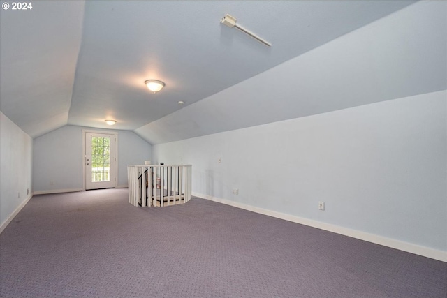 additional living space featuring carpet floors and lofted ceiling