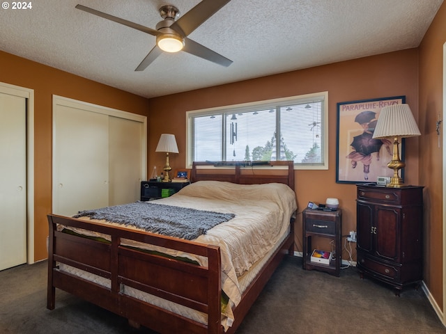 bedroom with ceiling fan, dark carpet, and a textured ceiling