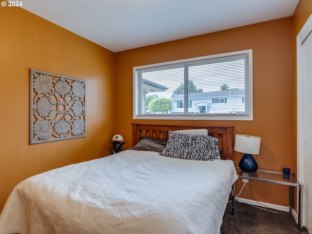 carpeted bedroom with a textured ceiling