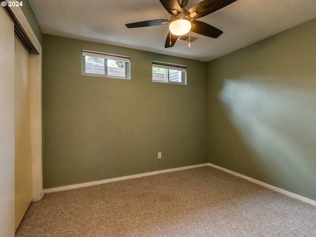 carpeted empty room with ceiling fan