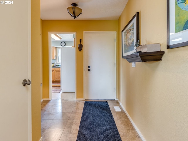 entryway with light tile patterned floors