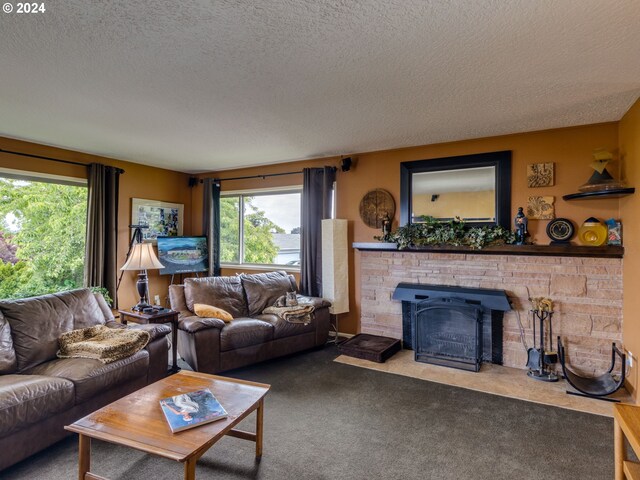 living room featuring a wealth of natural light, carpet floors, and a textured ceiling