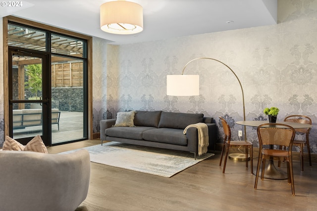 living room with a wall of windows and wood-type flooring