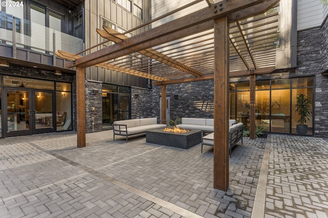 view of patio / terrace with a pergola and an outdoor living space with a fire pit