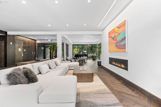 living room with wooden walls and parquet floors