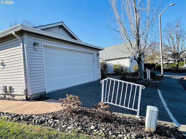 view of side of home featuring a garage and an outdoor structure