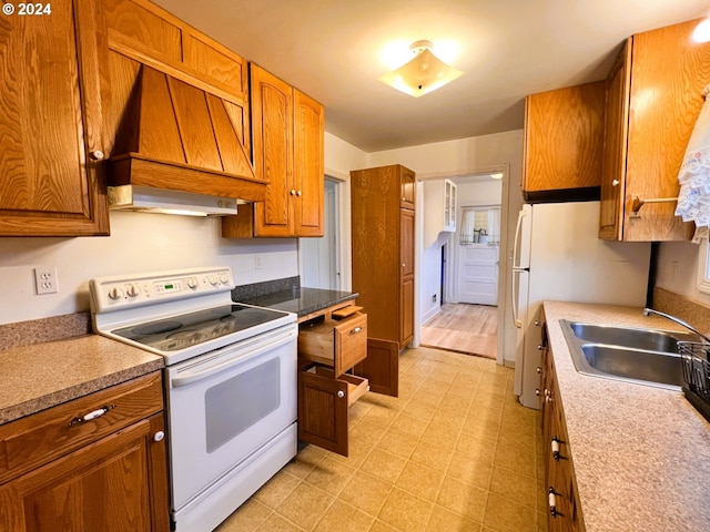 kitchen with white appliances, light hardwood / wood-style flooring, custom exhaust hood, and sink