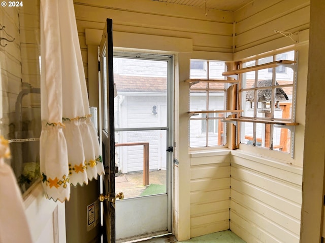 doorway featuring wood walls