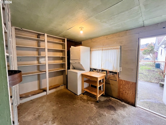 storage room featuring stacked washer / dryer