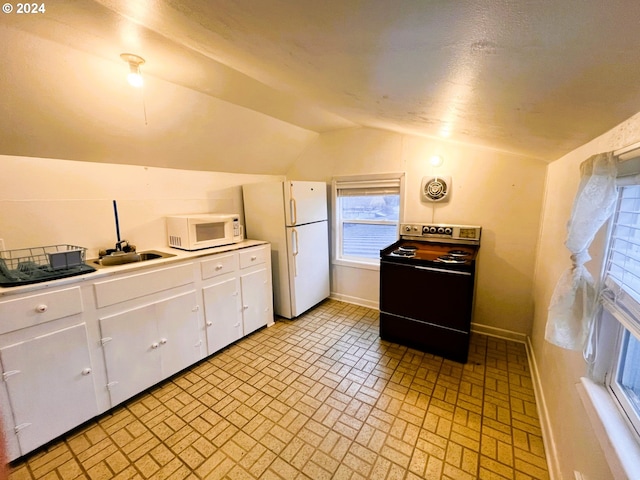 kitchen featuring vaulted ceiling, white cabinetry, and white appliances