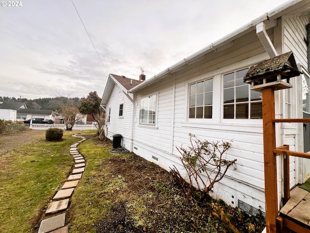 view of home's exterior with a yard