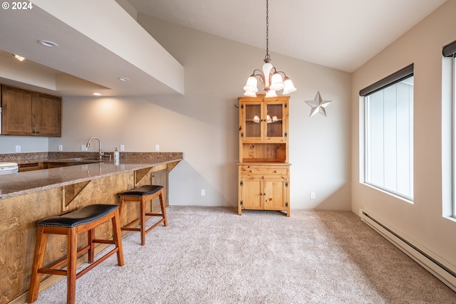 kitchen with baseboard heating, sink, a kitchen breakfast bar, and light colored carpet