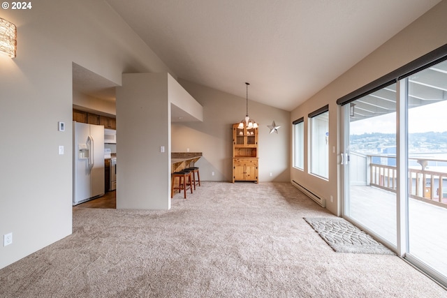 unfurnished dining area with a baseboard heating unit, a chandelier, vaulted ceiling, and carpet floors