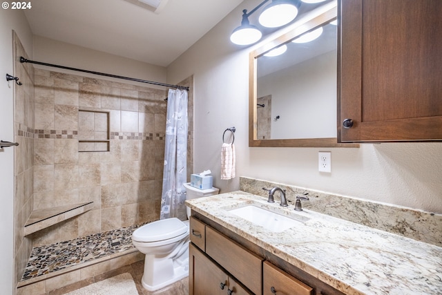 bathroom with vanity, a shower with curtain, toilet, and tile patterned floors