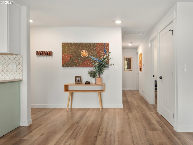 corridor with light wood-type flooring