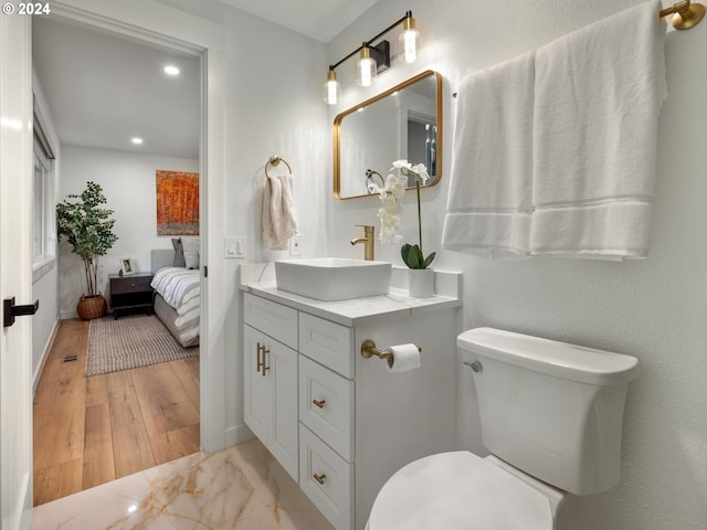 818 Ash St, Lake Oswego, OR 97034 - ensuite bathroom featuring vanity, recessed lighting, toilet, marble finish floors, and baseboards