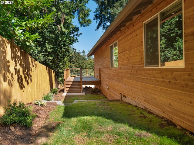 view of property exterior featuring a deck and a lawn