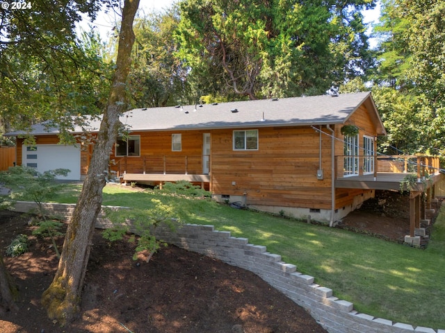 rear view of property with a lawn and a deck