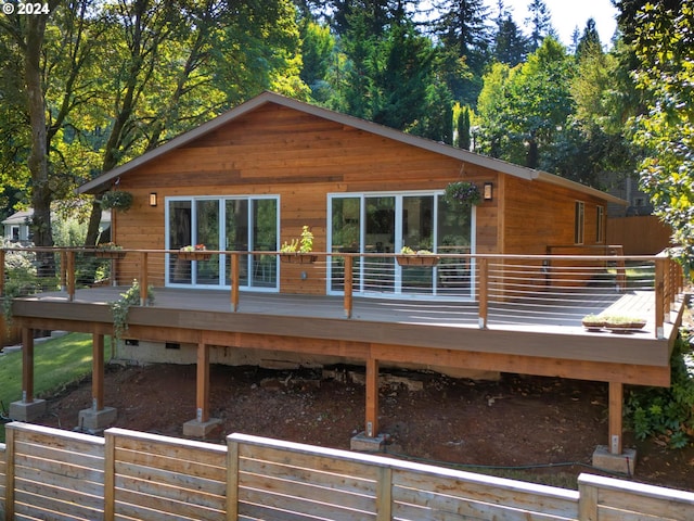 back of property featuring a wooden deck