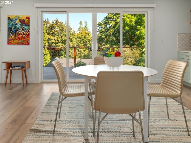 dining space with light wood-type flooring and a wealth of natural light