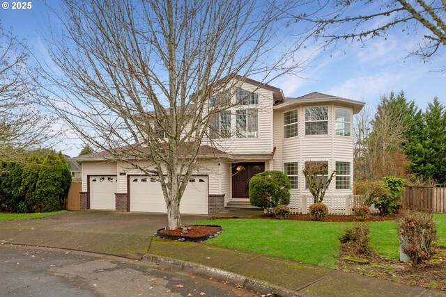 view of front of property with a garage and a front yard