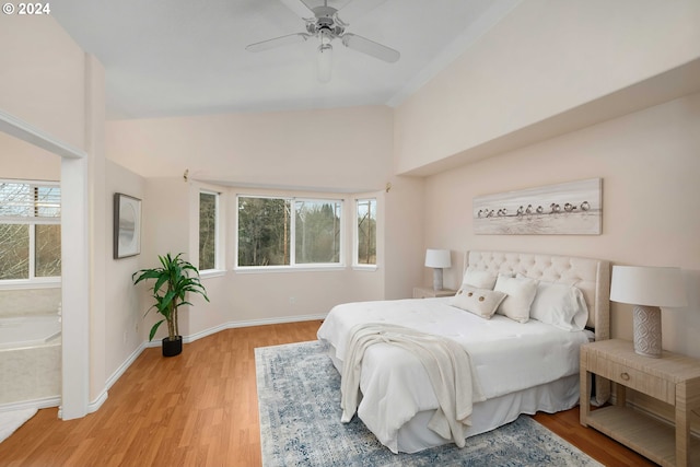 bedroom with vaulted ceiling, ceiling fan, and light wood-type flooring