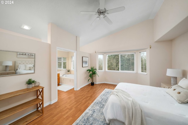 bedroom with ceiling fan, lofted ceiling, light hardwood / wood-style floors, and ensuite bath