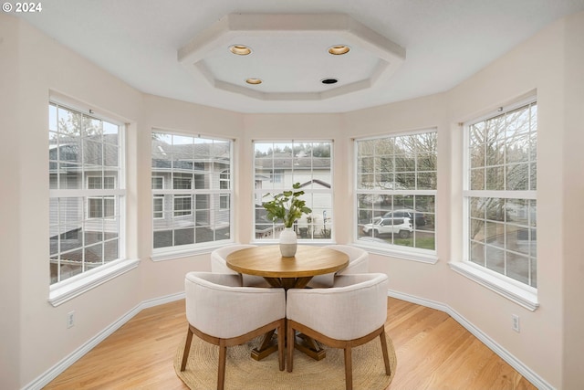 sunroom / solarium with a tray ceiling