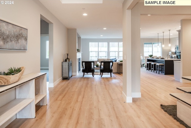 corridor featuring sink and light hardwood / wood-style flooring