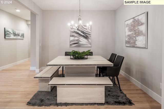 dining room with an inviting chandelier and light wood-type flooring