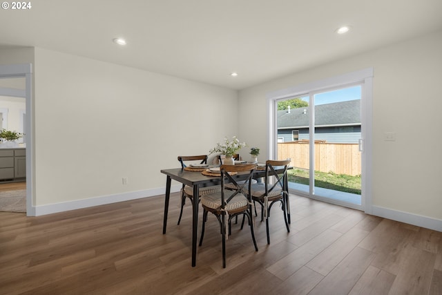dining area featuring wood finished floors, baseboards, and recessed lighting