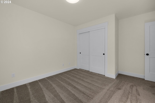 unfurnished bedroom featuring a closet and carpet flooring