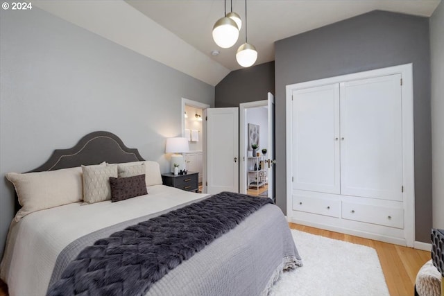 bedroom featuring light wood-type flooring and lofted ceiling