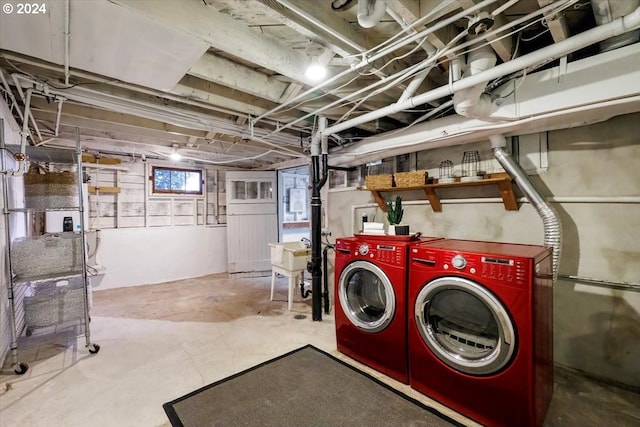 basement with washer and clothes dryer and sink