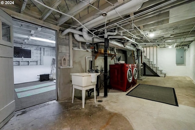 basement with electric panel and washer and clothes dryer