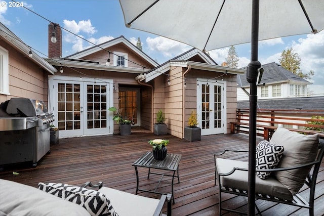 wooden terrace featuring a grill and french doors