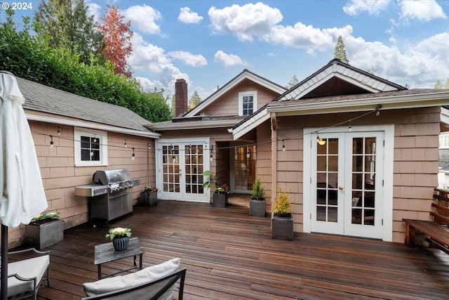 wooden deck with area for grilling and french doors