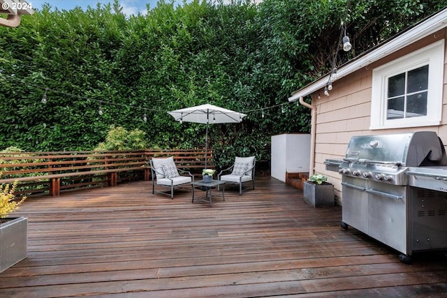 wooden terrace featuring grilling area