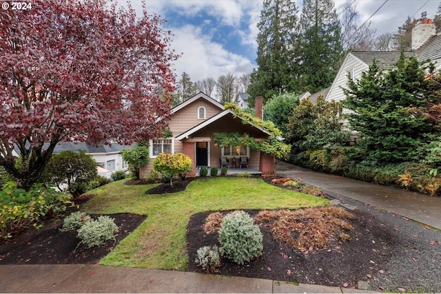 obstructed view of property featuring a front lawn