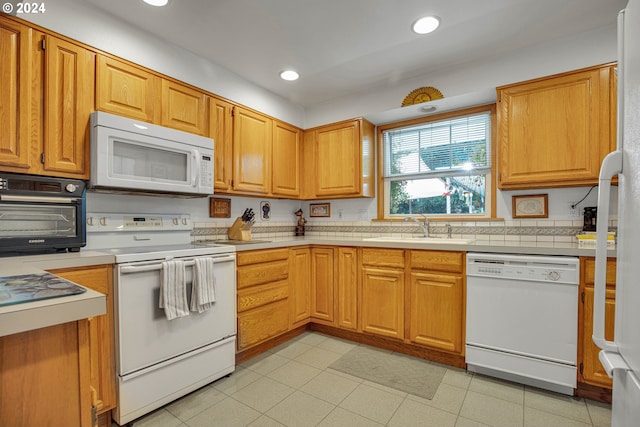 kitchen with sink and white appliances